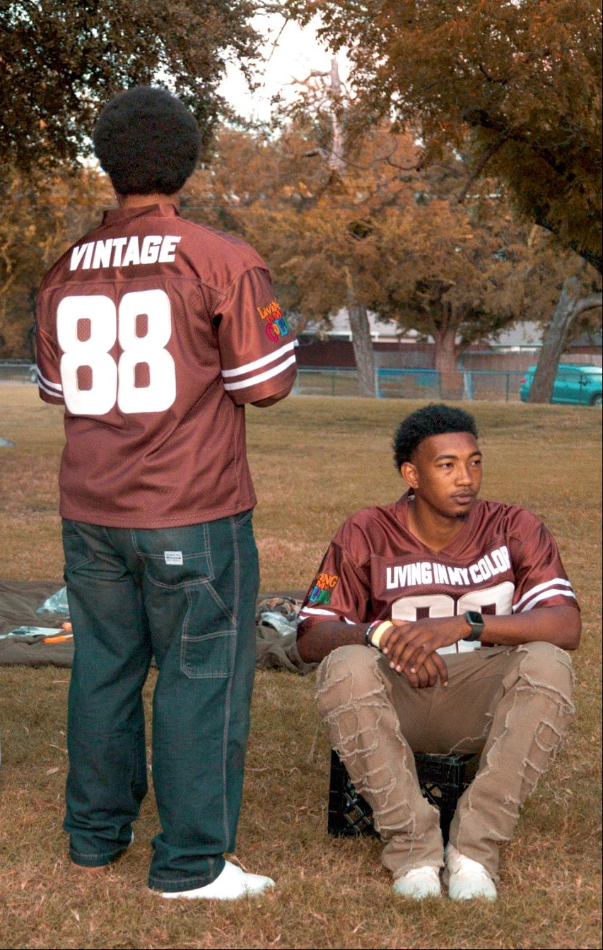 To people wearing VINTAGE’88® sports jerseys in a park