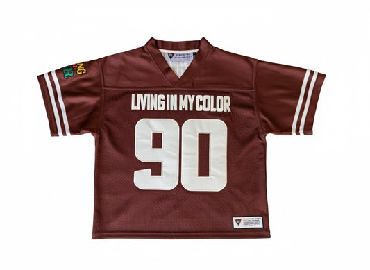 Brown sports jersey with 'Living in My Color' text and number 90 on a white background